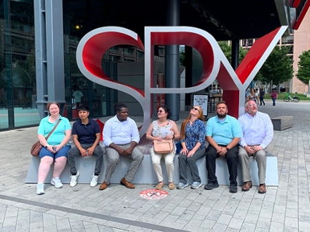 Middle Georgia State University School of Computing / Department of IT’s students Frieda Wilson, BSIT, (left to right) Paul Pasato Leon, MSIT, Coby Roye, BSIT, Lourdes Cols, BSIT, Stephanie James, BSIT, Hunter Gales, BSIT, and John Joyce, pose for a portrait outside of the Spy Museum where students learned about practices and cases involving governmental spying actions. 